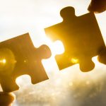 two puzzle pieces connecting like a content strategy and a content plan