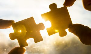 two puzzle pieces connecting like a content strategy and a content plan