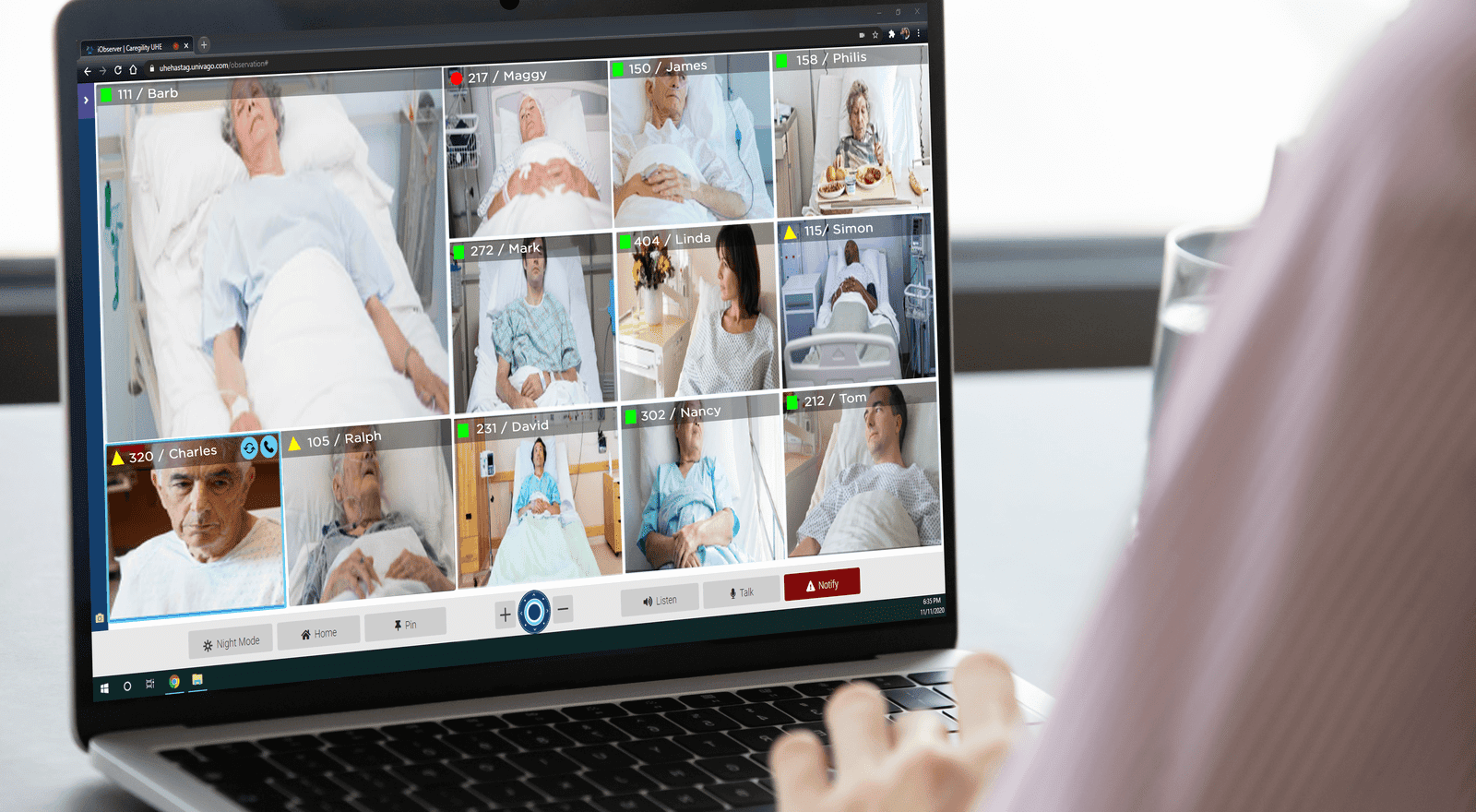 healthcare worker virtually watching patients via laptop